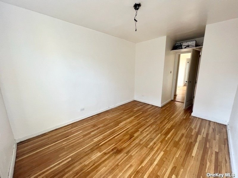 112-24 Northern Boulevard, Unit 4B Queens, NY 11368 - Photo 3 of 9 a view of empty room with wooden floor
