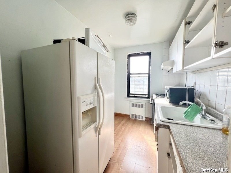 112-24 Northern Boulevard, Unit 4B Queens, NY 11368 - Photo 6 of 9 a living room with furniture and a fireplace