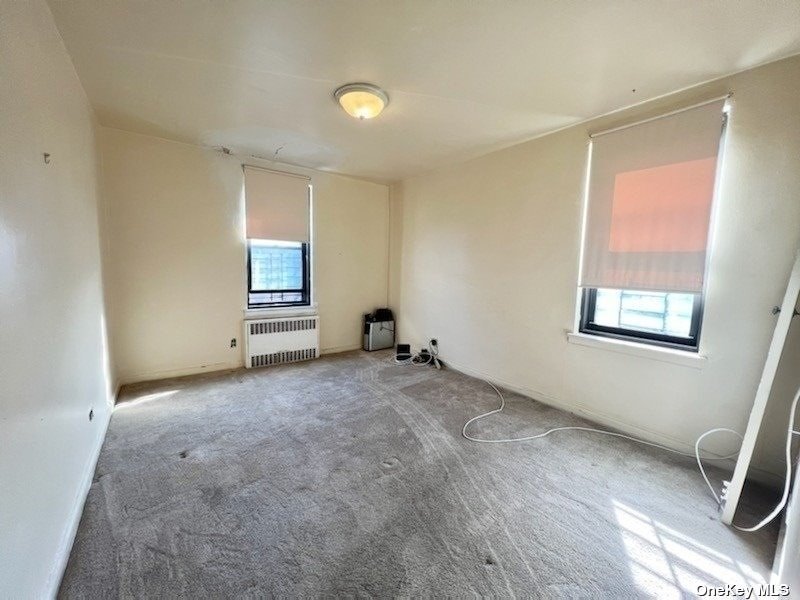 112-24 Northern Boulevard, Unit 4B Queens, NY 11368 - Photo 7 of 9 an empty room with windows