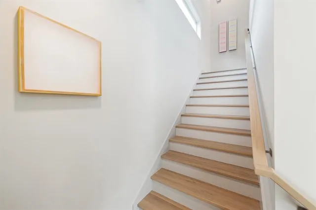 a view of staircase with white walls and a window