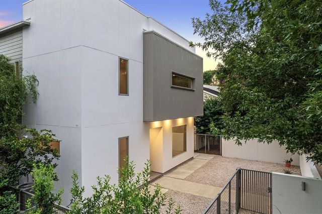 a front view of a house with trees