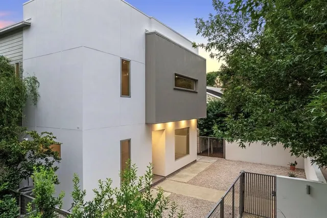 a front view of a house with trees