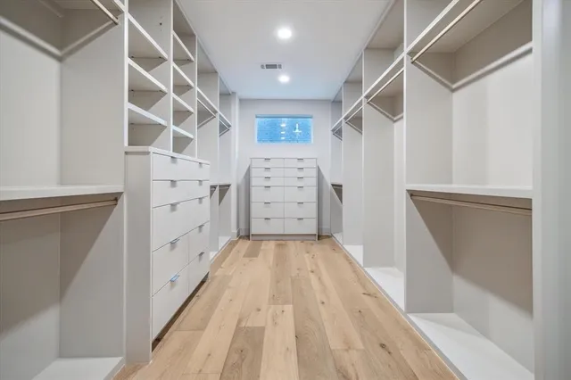 a view of walk in closet with empty racks