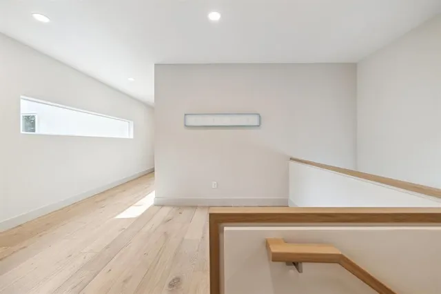 a view of a room with wooden floor