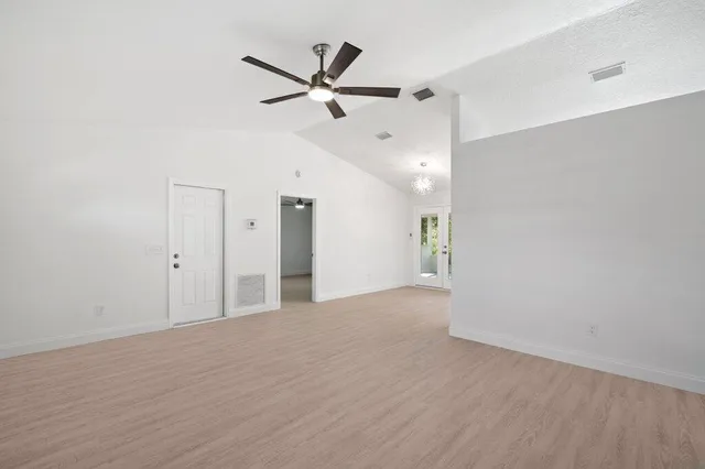a view of a livingroom with a ceiling fan and wooden floor