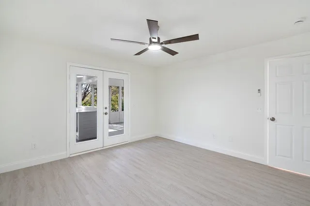 an empty room with windows and closet
