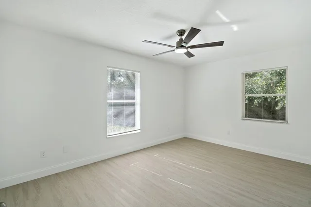 wooden floor in an empty room with a window