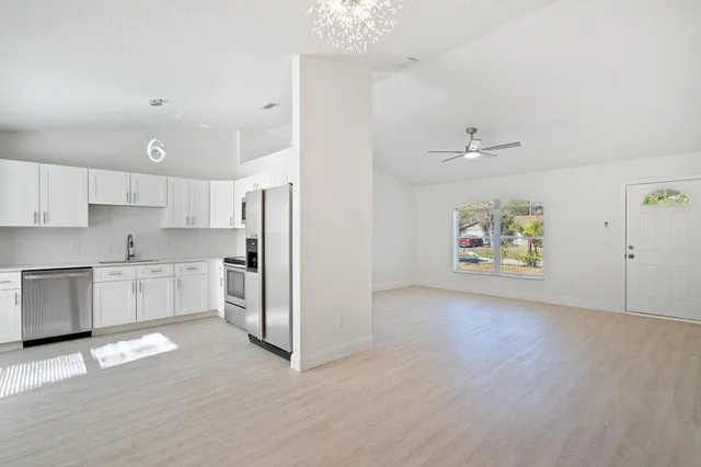 a large kitchen with cabinets and stainless steel appliances