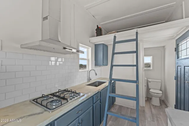 a kitchen with a sink cabinets and a window