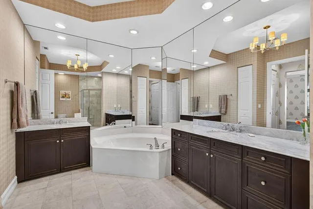 a large bathroom with a double vanity sink mirror and a bathtub