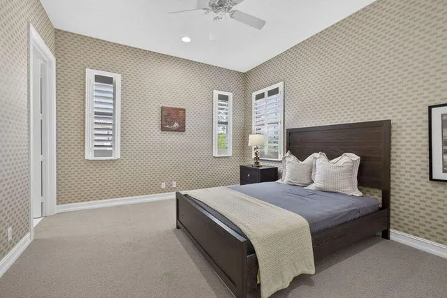 a bedroom with a large bed and a chandelier