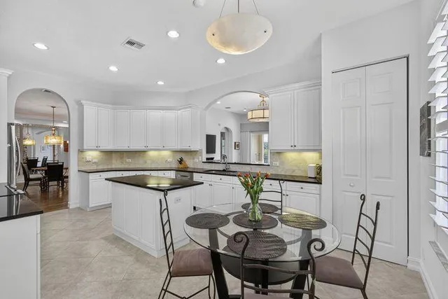a kitchen with granite countertop kitchen island cabinets and stainless steel appliances
