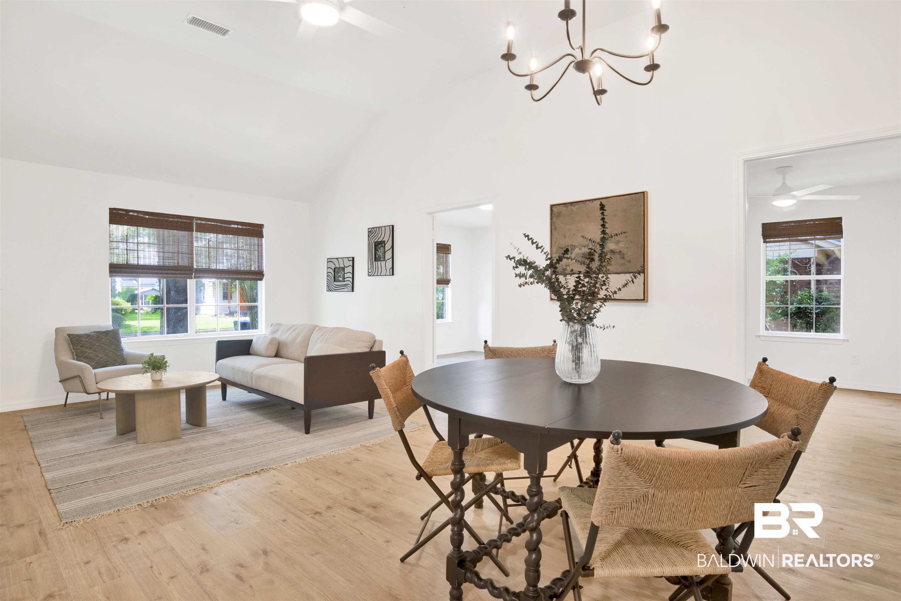317 Lee Street Chickasaw, AL 36611 - Photo 29 of 40 Dining area with a ceiling fan, light wood-style flooring, a chandelier, and high vaulted ceiling