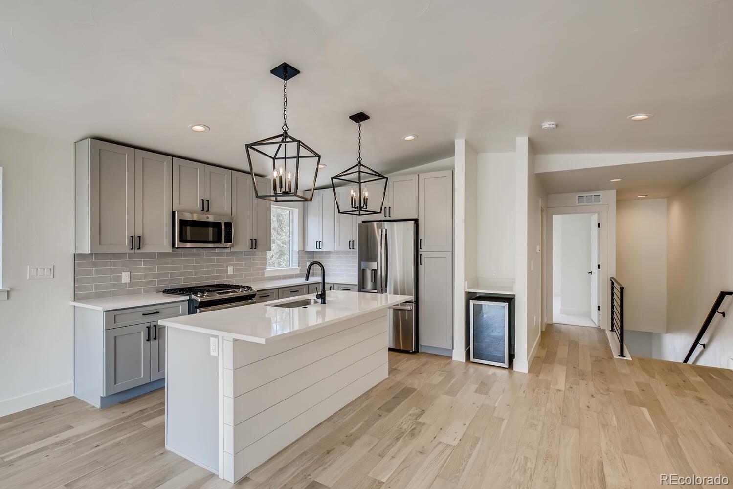 949 Raleigh Street, Unit 2 Denver, CO 80204 - Photo 11 of 26 a kitchen with stainless steel appliances granite countertop a refrigerator a stove oven a sink dishwasher and a refrigerator with wooden floor