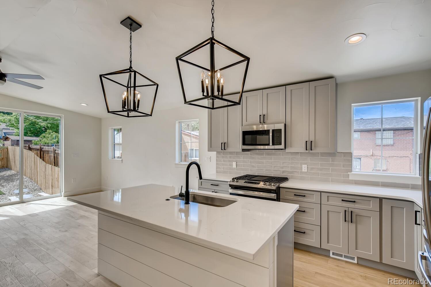 949 Raleigh Street, Unit 2 Denver, CO 80204 - Photo 12 of 26 a kitchen with stainless steel appliances a sink a stove and cabinets