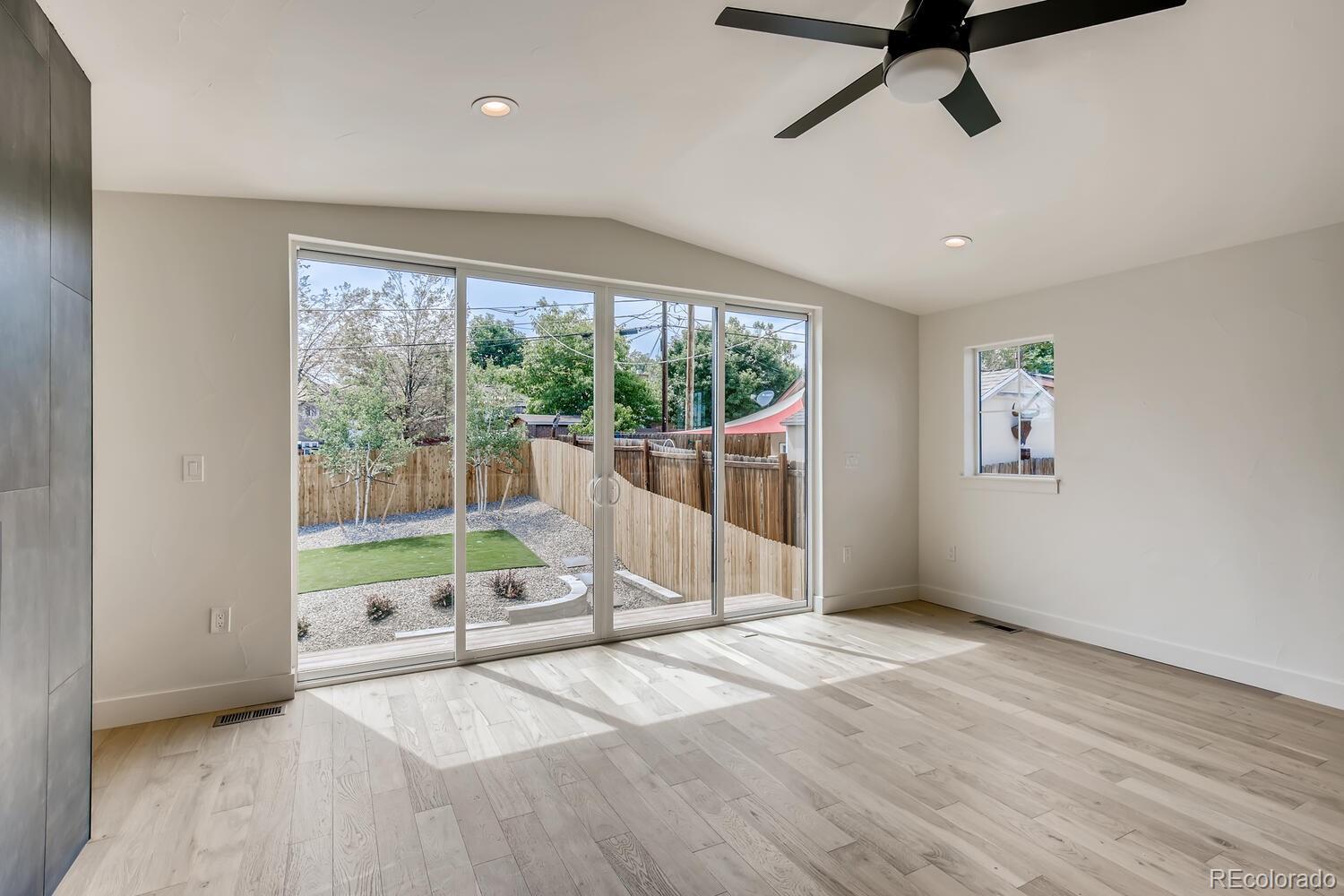 949 Raleigh Street, Unit 2 Denver, CO 80204 - Photo 16 of 26 a view of an empty room with wooden floor and windows