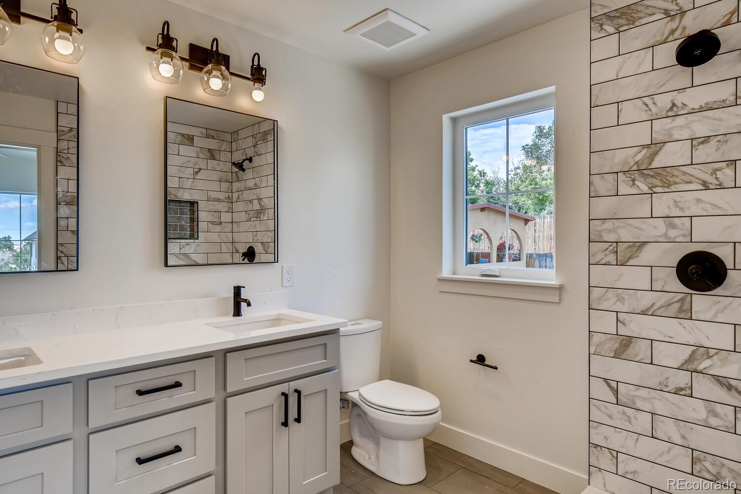949 Raleigh Street, Unit 2 Denver, CO 80204 - Photo 21 of 26 a bathroom with a sink and a mirror