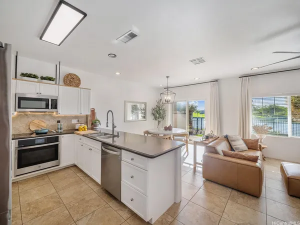 a kitchen with stainless steel appliances granite countertop a sink and cabinets