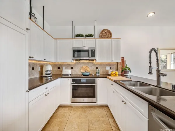 a kitchen with stainless steel appliances granite countertop a sink and a stove