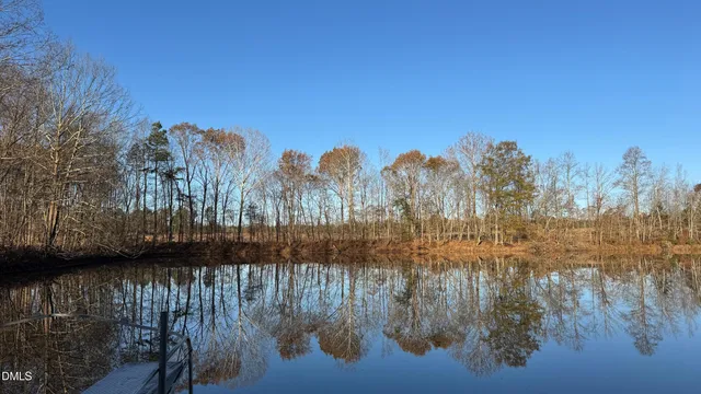 a view of dirt field with trees in the background