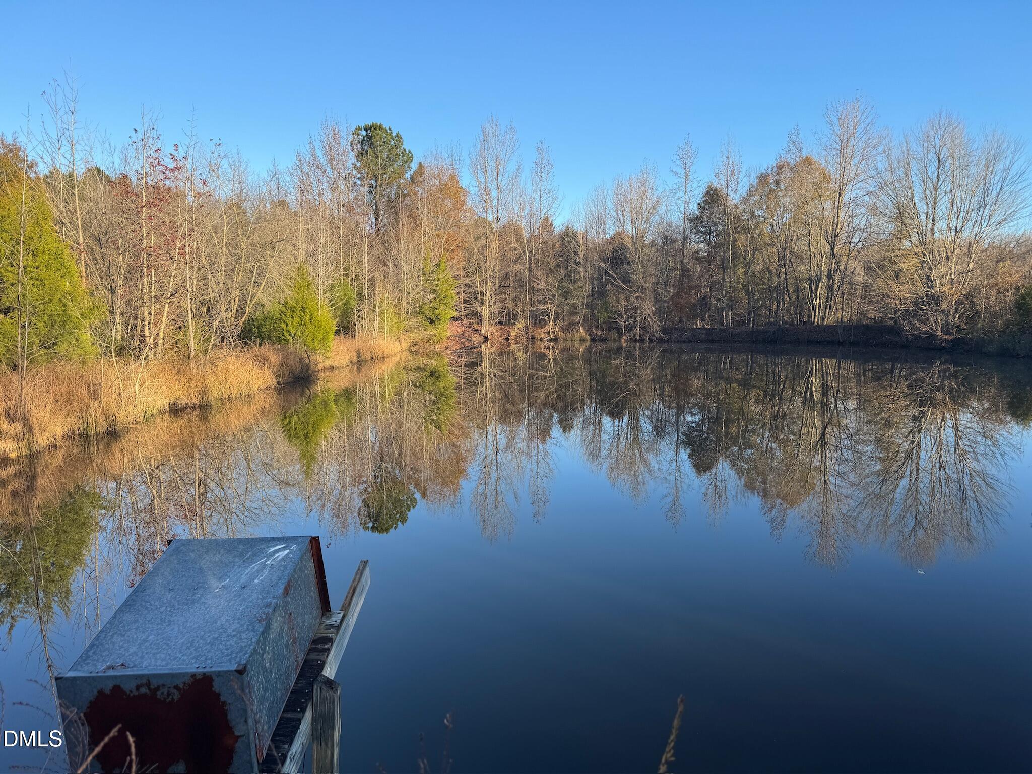 1604 Bonlee School Road Bear Creek, NC 27207 - Photo 21 of 71 a view of a lake with a mountain in the background