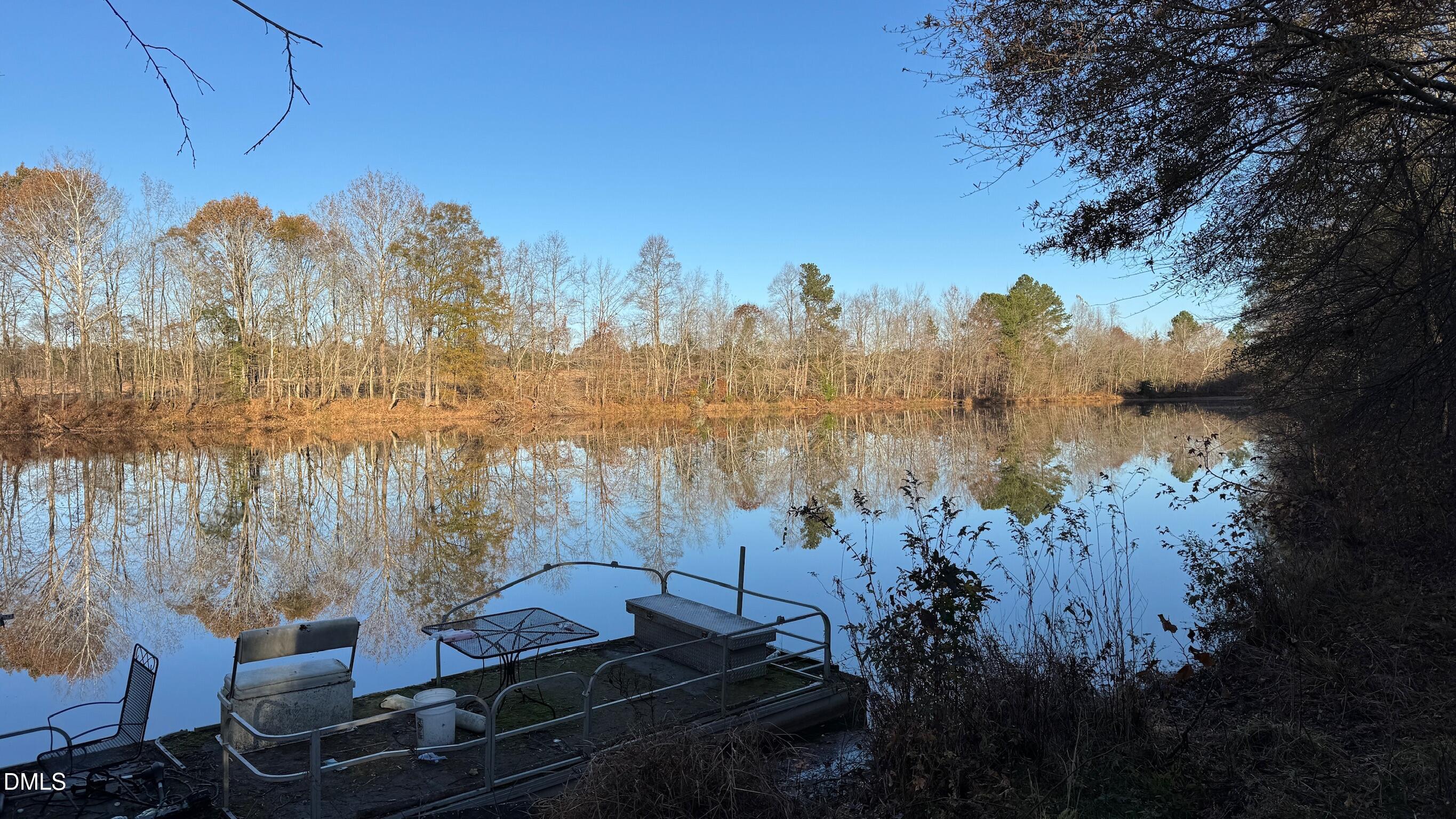 1604 Bonlee School Road Bear Creek, NC 27207 - Photo 5 of 71 a view of a lake with a mountain in the background