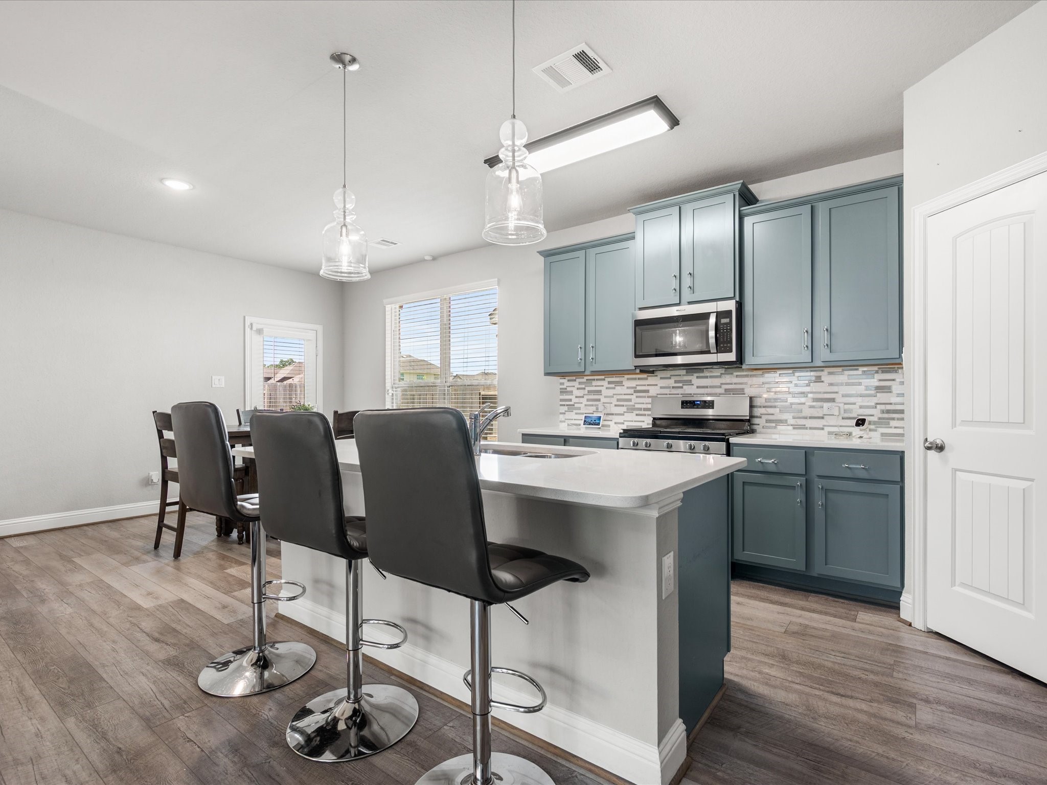 7123 Poppyseed Trail Spring, TX 77379 - Photo 10 of 30 The heart of the home features a breakfast bar island, beautiful cabinetry, and a spacious walk-in pantry designed to keep everything within easy reach.