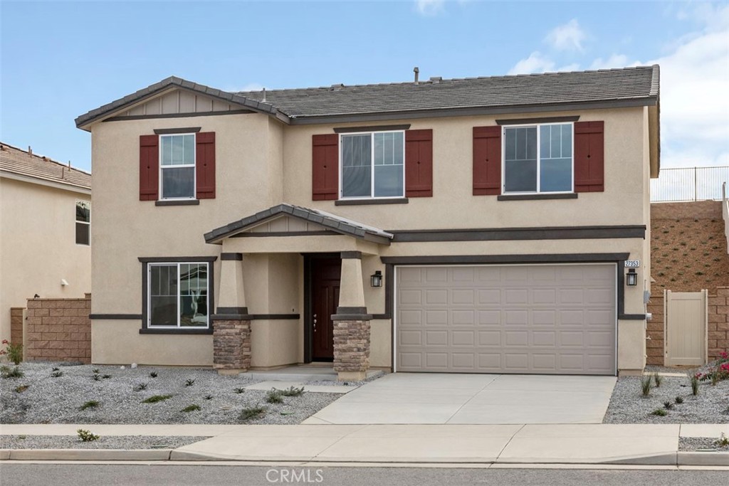 a front view of a house with garage