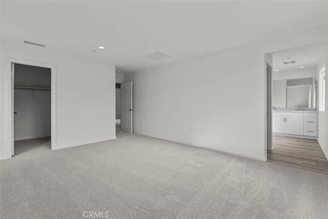 an empty room with closet and mirror