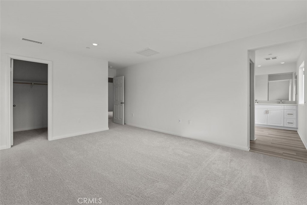 27353 Dunite Drive Perris, CA 92571 - Photo 13 of 18 an empty room with closet and mirror