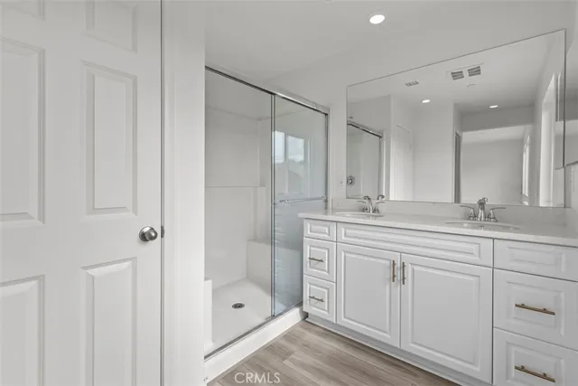 a bathroom with a shower sink and mirror