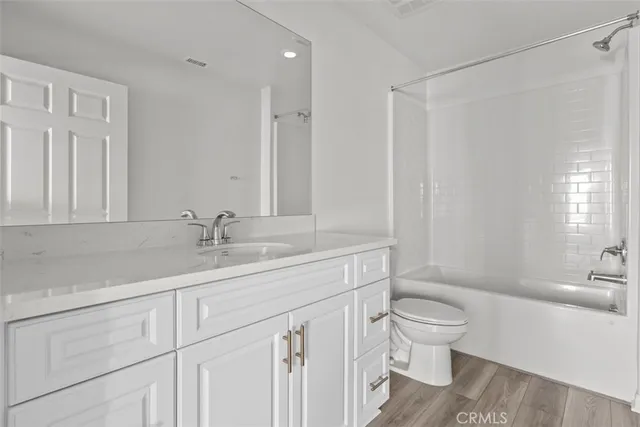 a bathroom with a sink toilet a mirror and vanity