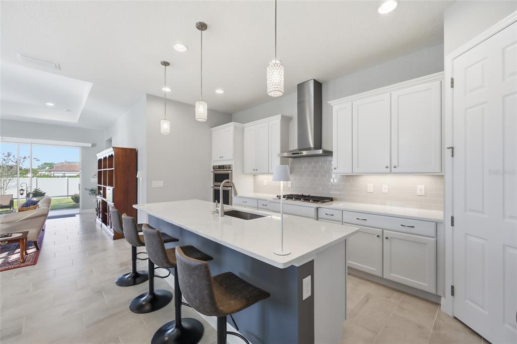 2154 Wallingford Loop Mount Mount Dora, FL 32757 - Photo 16 of 52 a kitchen with a table chairs refrigerator and microwave