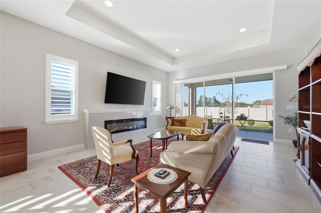 2154 Wallingford Loop Mount Mount Dora, FL 32757 - Photo 19 of 52 a living room with furniture a flat screen tv and a fireplace
