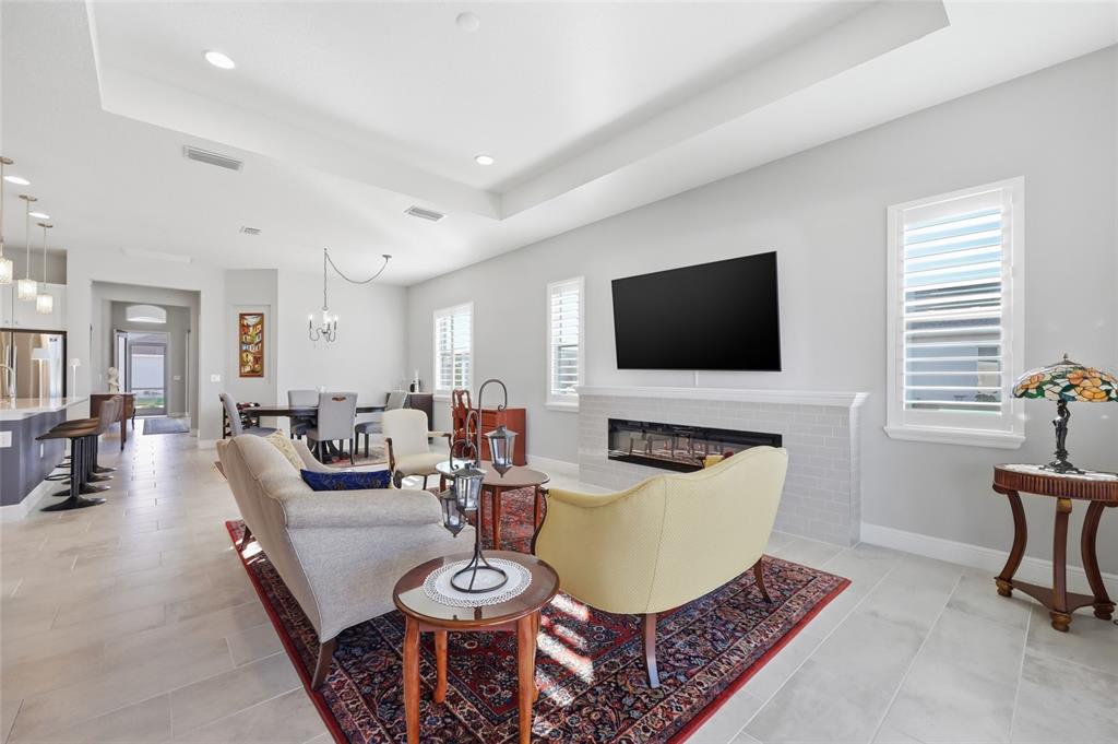 2154 Wallingford Loop Mount Mount Dora, FL 32757 - Photo 20 of 52 a living room with furniture and a flat screen tv