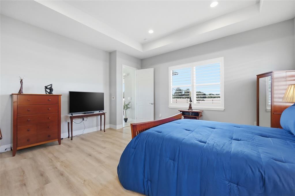 2154 Wallingford Loop Mount Mount Dora, FL 32757 - Photo 24 of 52 a bedroom with a bed and a flat screen tv