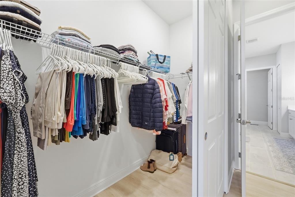2154 Wallingford Loop Mount Mount Dora, FL 32757 - Photo 27 of 52 a view of walk in closet with clothes and shoes