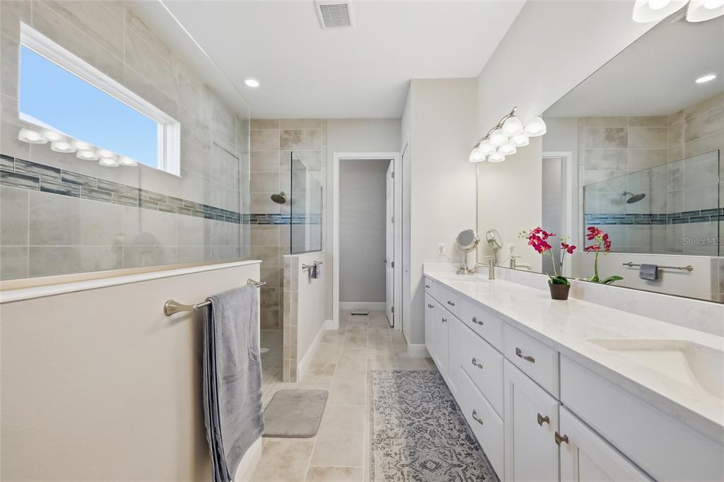 2154 Wallingford Loop Mount Mount Dora, FL 32757 - Photo 28 of 52 a spacious bathroom with a double vanity sink mirror and a shower
