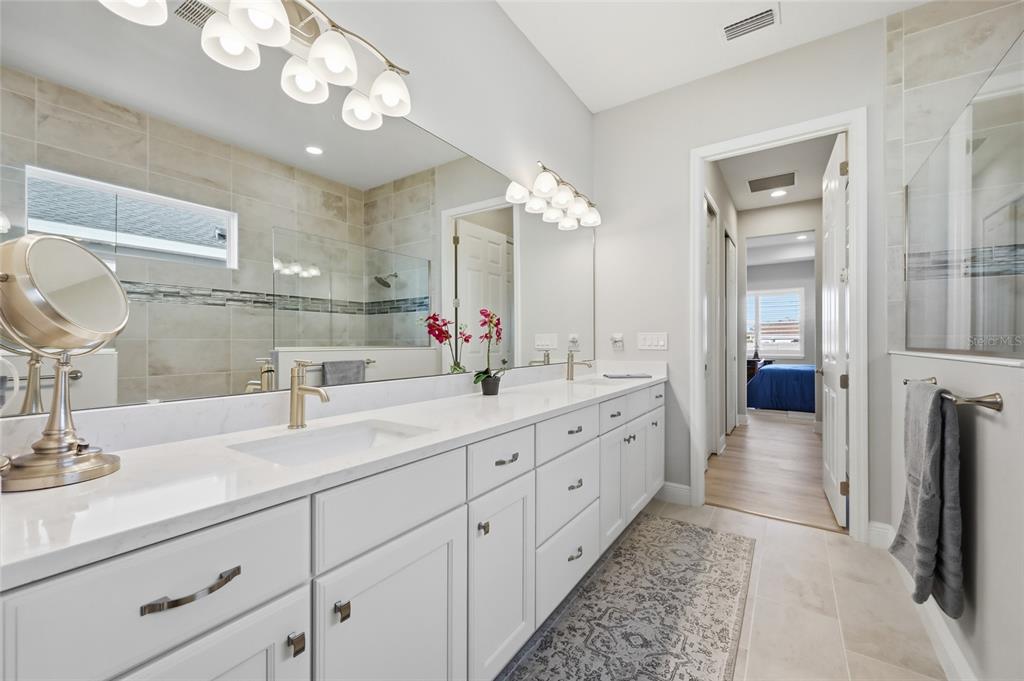 2154 Wallingford Loop Mount Mount Dora, FL 32757 - Photo 29 of 52 a bathroom with a double vanity sink and a mirror