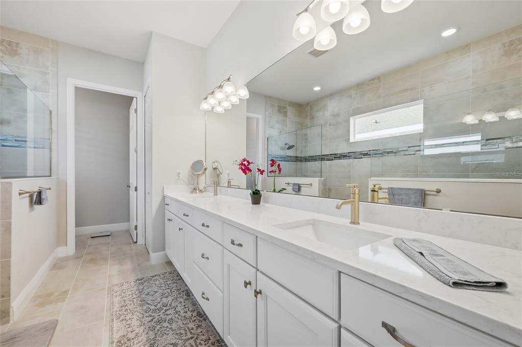 2154 Wallingford Loop Mount Mount Dora, FL 32757 - Photo 30 of 52 a spacious bathroom with a sink double vanity and a mirror
