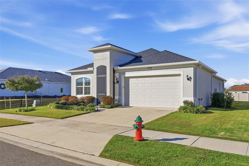 2154 Wallingford Loop Mount Mount Dora, FL 32757 - Photo 3 of 52 a front view of a house with a yard and garage