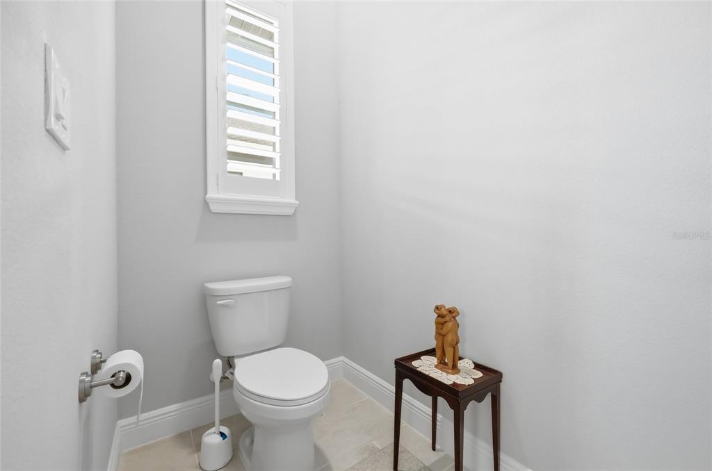 2154 Wallingford Loop Mount Mount Dora, FL 32757 - Photo 33 of 52 a bathroom with a toilet a sink and mirror