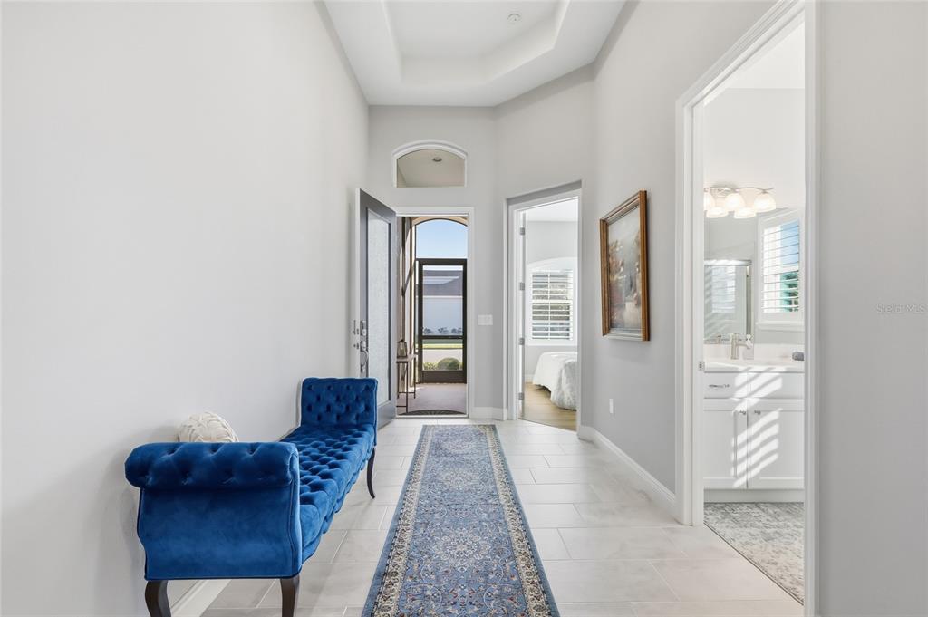 2154 Wallingford Loop Mount Mount Dora, FL 32757 - Photo 6 of 52 a hallway with furniture and a rug