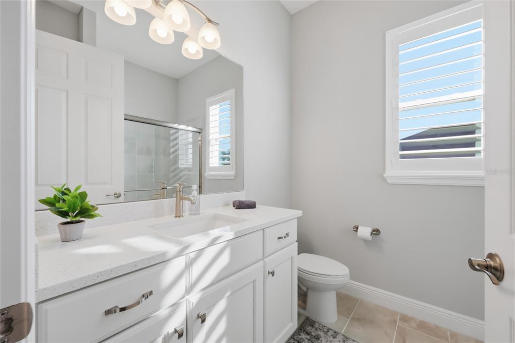 2154 Wallingford Loop Mount Mount Dora, FL 32757 - Photo 8 of 52 a bathroom with a sink a toilet and a mirror