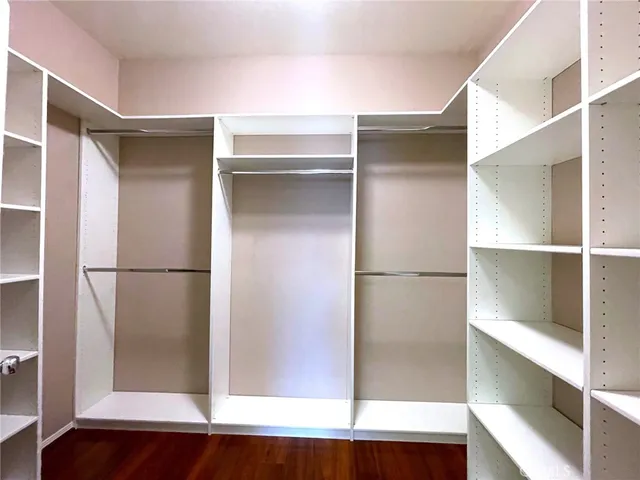 a view of walk in closet with empty racks