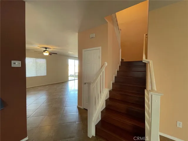 a view of a hallway with wooden floor and entryway
