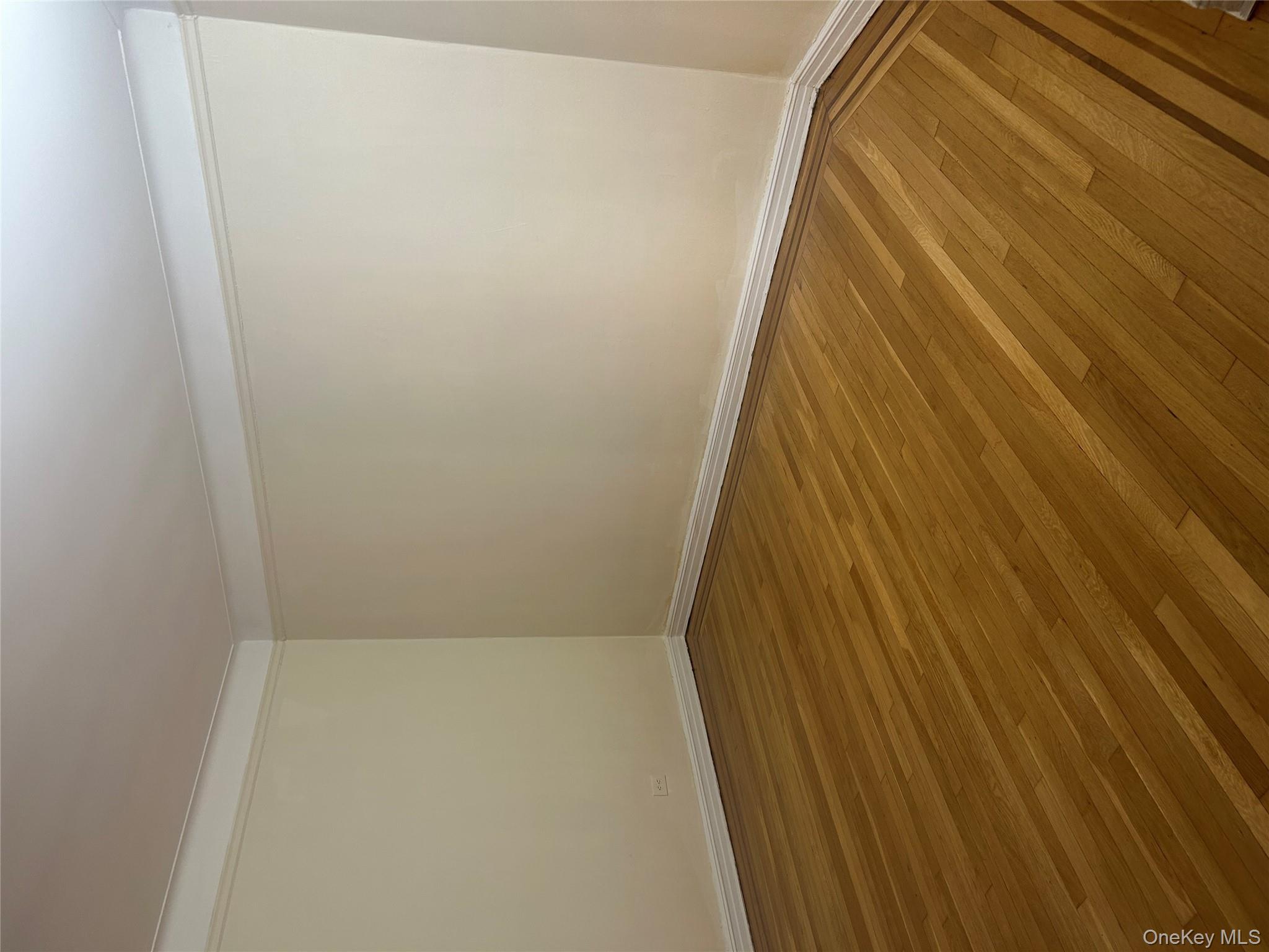 15501 90th Avenue, Unit 3M Queens, NY 11432 - Photo 4 of 6 a view of an empty room with wooden floor