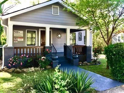 a front view of a house with a garden and patio