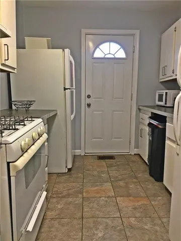 a kitchen with a refrigerator a stove a washer and dryer