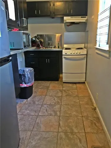 a kitchen with a stove and cabinets